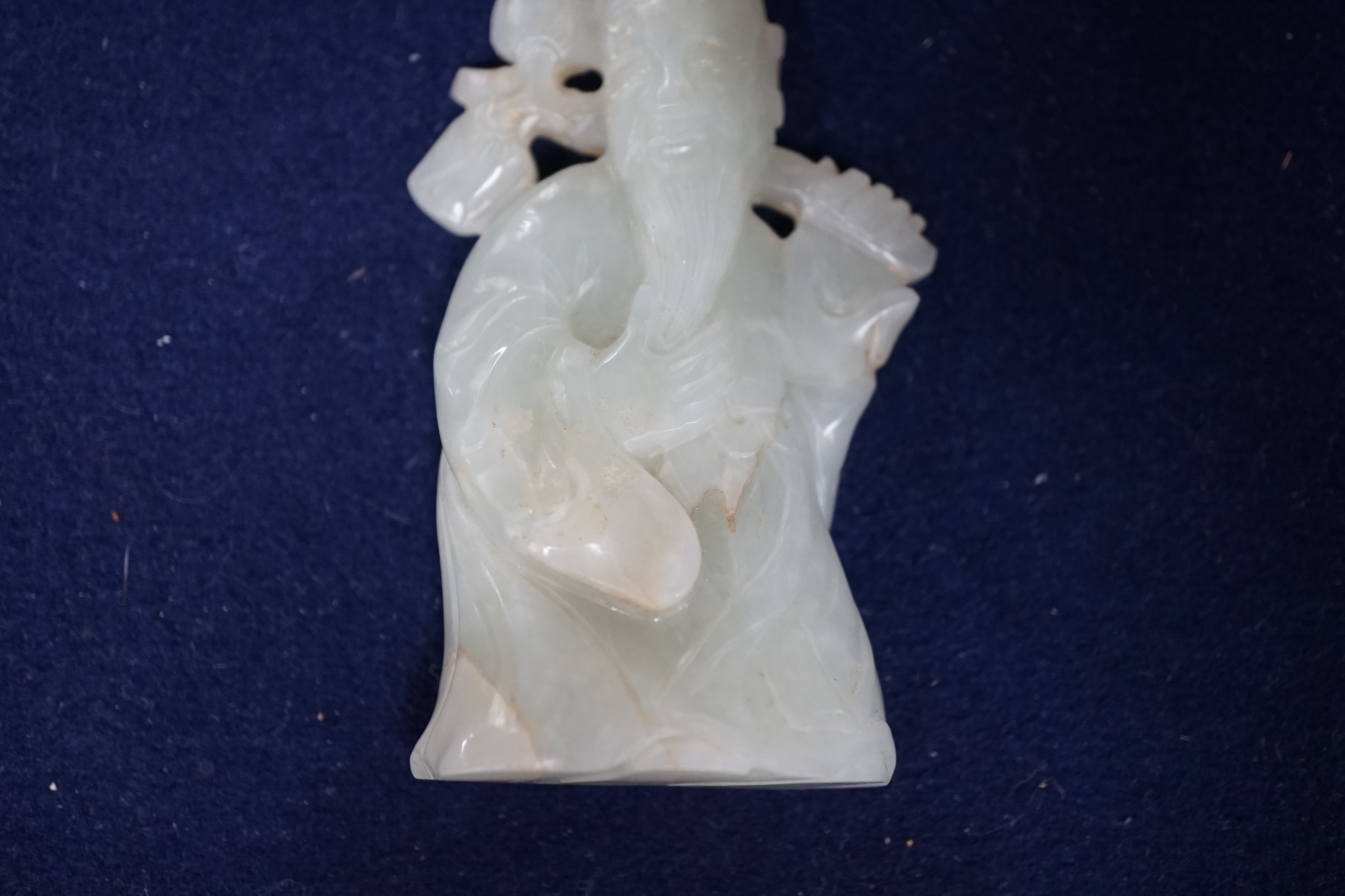 A Chinese pale celadon jade figure of Shou Lao, wood stand, 10cm high
